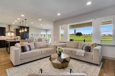 a living room filled with furniture and windows