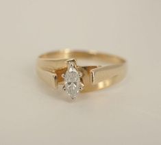 a yellow gold ring with a single diamond