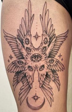 a woman's thigh with an owl and moon tattoo on it