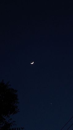 the moon and venus are visible in the night sky