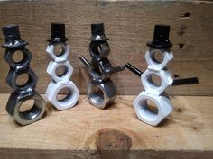 four different types of pipe clamps sitting on top of a wooden table