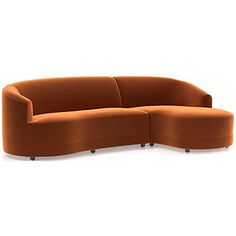 an orange curved couch sitting on top of a white floor