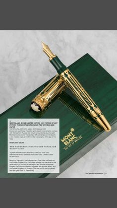 a green and gold fountain pen sitting on top of a book with writing underneath it