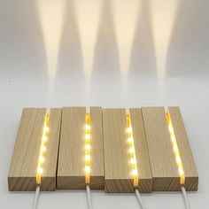 four wooden blocks with yellow lights on them