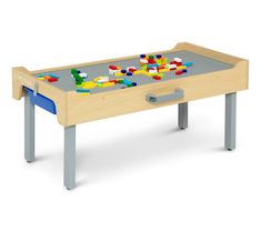 a child's wooden table with legos on the top and bottom, in front of a white background