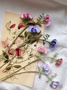 some flowers are laying on top of a piece of paper