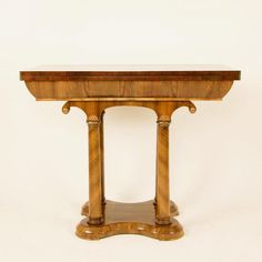 a wooden table with two pillars on top