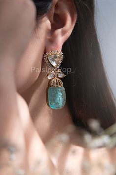 The Victorian Polki Earrings feature a pair of sea green doublet stones at their focal point, emulating the mesmerizing hues of the ocean. The polished top of the earrings showcases intricate polki work. To enhance its brilliance, the earrings are adorned with cubic zirconia. These cocktail earrings are sure to make a statement and evoke a sense of serene and sophistication. Closure - Push Back Paisley Pop travels the depths of India to learn techniques and crafts from deep down in the local markets and villages. We give utmost importance to our quality and packaging. Our goal is to make sure you receive exactly what you are looking for and for your experience to be a special and memorable one. We are ready to help and advise you through your purchase. IT' S  A W E S O M E * Ethically Sour Turquoise Jewelry For Party, Luxury Stone Work Earrings For Festivals, Victorian Earrings Indian, Turquoise Kundan Earrings For Wedding, Green Handmade Bollywood Bridal Earrings, Turquoise Gemstone Earrings For Party, Antique Mughal Jewellery, Victorian Earrings, Green Polki Earrings