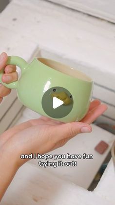 a person holding a green coffee cup with a bird on it's side and the caption says, and i hope you have fun trying it out