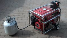 a red and white fire hydrant sitting on top of a sidewalk next to a small machine