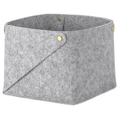 a grey felt storage bin with gold buttons