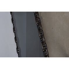 two different views of a chain hanging on the wall