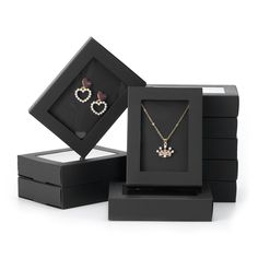 three jewelry boxes with two necklaces in them