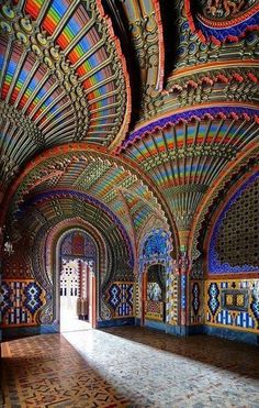 the inside of an ornate building with colorful walls and ceilings