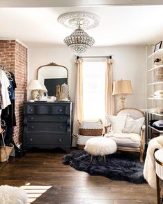 a bedroom with a dresser, chair and mirror