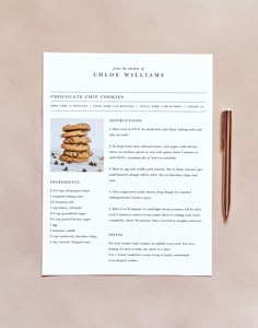 a recipe book on top of a table next to a pen and paper with an image of chocolate chip cookies