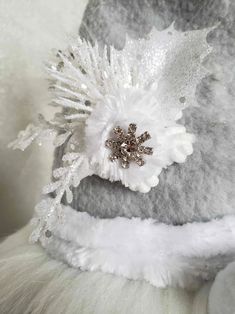 a close up of a white hat with snow flakes on it's side