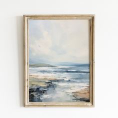 a painting hanging on the wall next to a white wall with a wooden framed frame