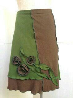 a skirt on a mannequin with green and brown fabric, flower appliques