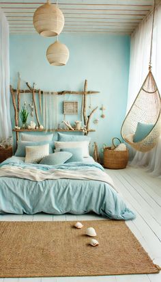 a bedroom decorated in blue and white with hammock hanging from the ceiling