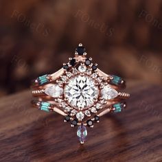 a close up of a ring on top of a wooden table with diamonds and blue stones