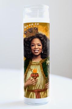 a candle with an image of a woman wearing a crown on top of her head