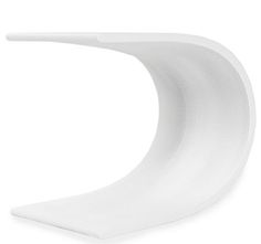 the curved white table is on display against a white background and has an interesting shape