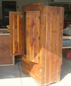 an old wooden armoire sitting in the middle of a garage