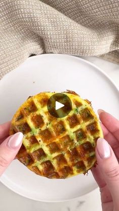 someone holding a waffle with a hole in the middle