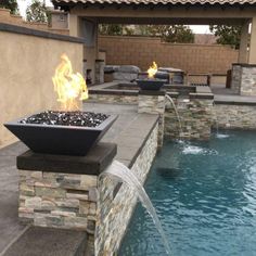 a fire pit sitting next to a swimming pool