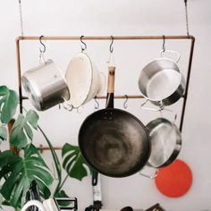 pots and pans hanging from a rack in a kitchen