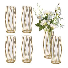 four gold vases with flowers in them on a white background and one is empty