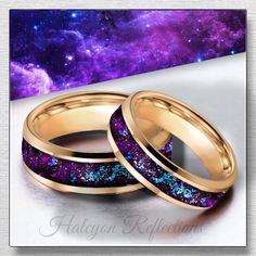 two gold wedding bands with purple and blue glitter in front of a galaxy background,