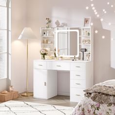 a bedroom with a white vanity and flowers on the bed, next to a large window