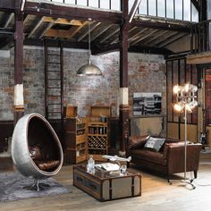 a living room filled with furniture and brick walls