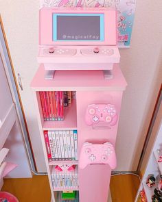 a pink toy computer and game system in a room