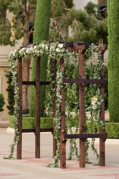 an outdoor ceremony setup with greenery and flowers