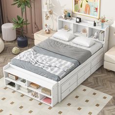 a white bed sitting in a bedroom next to a wooden floor