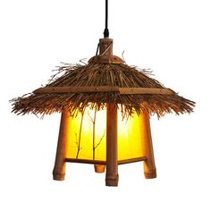 a light that is made out of straw and has a lamp hanging from it's side