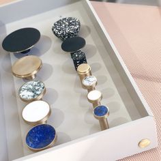 an assortment of different colored knobs in a box