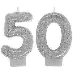 the number 50 candle is made out of silver glitter