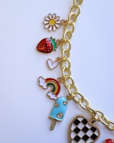 Add a splash of sunshine to your style with our Bright Summer-Themed Gold Plated Charm Necklace. This fun and vibrant accessory features an array of playful summer charms, perfect for capturing the season's essence. Measuring 17 inches in length, it's the ideal piece to brighten up any summer outfit. Crafted with high-quality gold plating, this necklace is designed to bring a touch of joy and color to your wardrobe. Trendy Necklaces With Removable Dangle Charms, Trendy Metal Charm Necklace With Lobster Clasp, Playful Multicolor Jewelry With Adjustable Chain, Trendy Dangle Charm Necklaces With Removable Charms, Playful Summer Dangle Jewelry, Multicolor Summer Jewelry, Handmade Playful Summer Necklaces, Playful Handmade Summer Necklaces, Casual Gold Necklaces For Summer