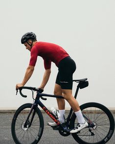 a man riding a bike on top of a parking lot