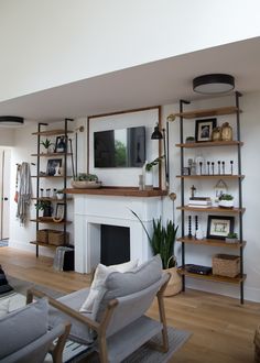 a living room filled with furniture and a fire place in the middle of a room