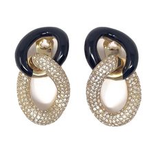 A wonderful example of Christian Dior's 1980s classic gold plated jewellery, these earrings are clip on. Condition Report: Excellent The Details... These gold plated earrings feature two large interlocking hoops. One hoop is detailed with black enamel and the other features pavé set, small, round, colourless rhinestones. The earrings are signed. The back of each clip is stamped with 'ChrDior', a copyright symbol and 'GERMANY'. They come with their original store card and tag. These earrings meas Lion Earrings, Copyright Symbol, Dior Earrings, Gold Plated Jewellery, Statement Hoop Earrings, Dior Jewelry, Couture Jewelry, Jewelry Manufacturers, Classic Gold