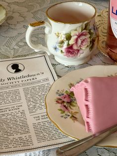 a piece of cake on a plate next to a cup and saucer