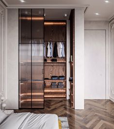 a bedroom with a bed, closet and clothes on the shelves next to each other