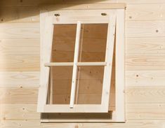 an open window on the side of a wooden building