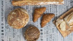 breads and pastries laid out on a newspaper