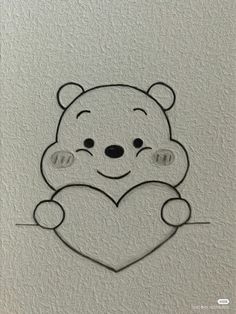 a drawing of a teddy bear holding a heart on a white paper with black outline